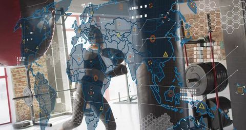 Female athlete punching heavy bag in industrial gym with global analytics hud overlay
