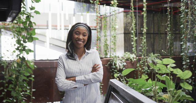 Confident Businesswoman with Green Plants in Modern Office - Download Free Stock Images Pikwizard.com