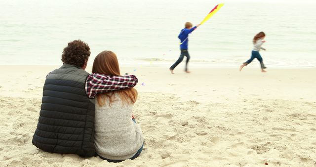 Family Bonding by Beach as Children Fly Colorful Kite - Download Free Stock Images Pikwizard.com