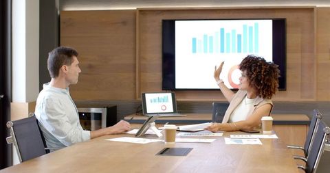 Diverse Coworkers Analyzing Data on Tablet in Office Meeting
