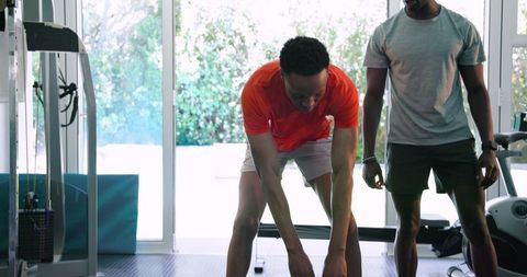 Young men engaged in home kettlebell workout routine