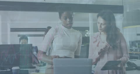 Businesswomen Collaborating with Financial Data Graphics