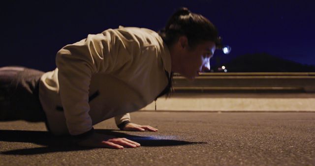 Determined Woman Doing Push-Ups on Urban Street at Night - Download Free Stock Images Pikwizard.com