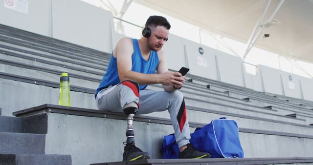 Para-athlete Using Smartphone on Stadium Steps During Workout Break - Download Free Stock Images Pikwizard.com