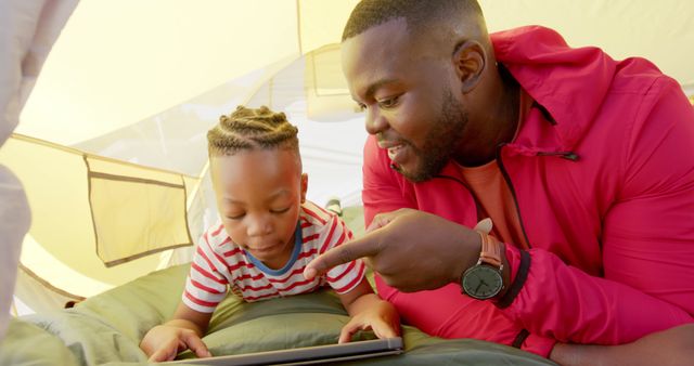 Father and Son Enjoying Tablet Time in Tent Outdoors - Download Free Stock Images Pikwizard.com