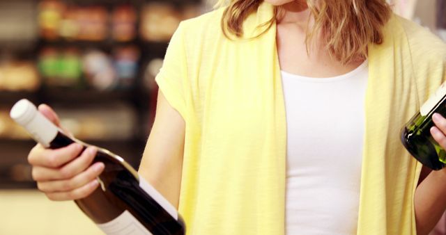 Woman Choosing Wine Bottle in Grocery Store - Download Free Stock Images Pikwizard.com