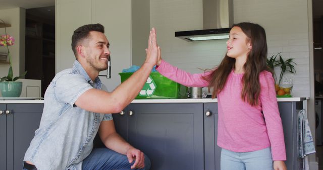 Father and Daughter High-Fiving in Kitchen - Download Free Stock Images Pikwizard.com