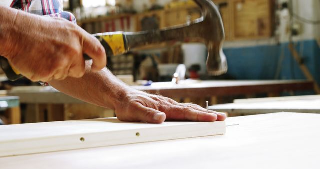 Carpenter Nailing Wood in Workshop - Download Free Stock Images Pikwizard.com