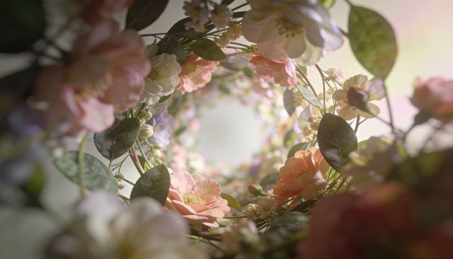Glowing pastel floral wreath tunnel, macro blossom ring with soft sunlit bokeh, dreamy vignette