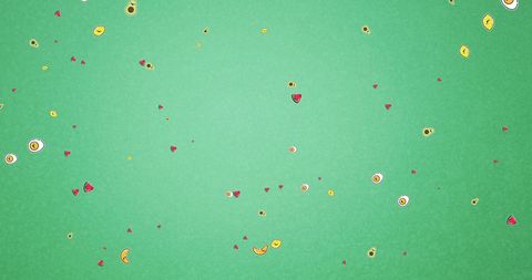 Colorful Falling Heart-Shaped and Round Confetti on Green Background