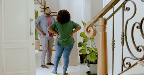 Couple plans home setup by new staircase