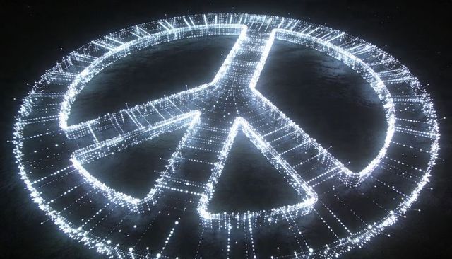 Glowing peace symbol creating halo of hanging lights, nighttime outdoor light installation