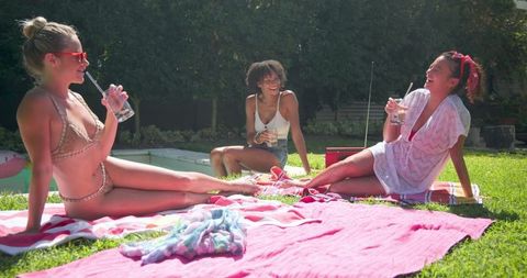 Diverse Women Socializing and Relaxing by Poolside