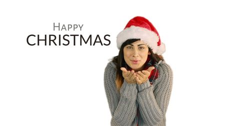 Festive woman blowing kiss with christmas greeting