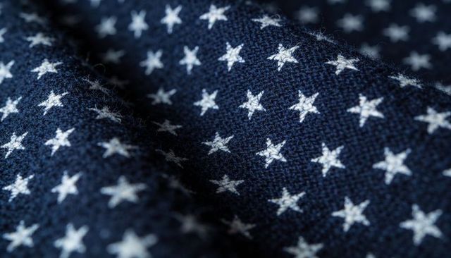 Macro Closeup of Navy Blue Knitted Fabric Featuring White Star Pattern and Textured Weave
