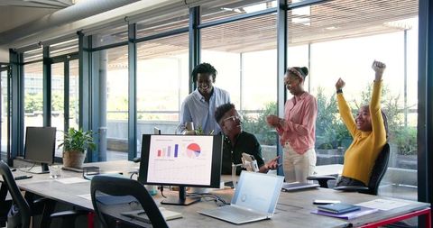 Diverse Team Celebrates Successful Project with Digital Presentation