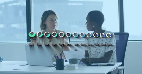 Diverse Business Female Colleagues Analyzing Financial Data in Modern Office