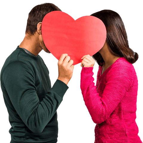 man and woman stand close holding red heart covering faces. photo symbolizes romantic bond, love, or privacy in relationships. perfect for valentine's day promotions, social media posts about love, or advertisements focusing on affection and couples.