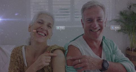 Older couple celebrating wellness with bandages and smiles
