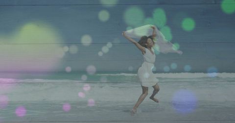 Woman in White Dress Running on Sandy Beach with Bokeh Lights