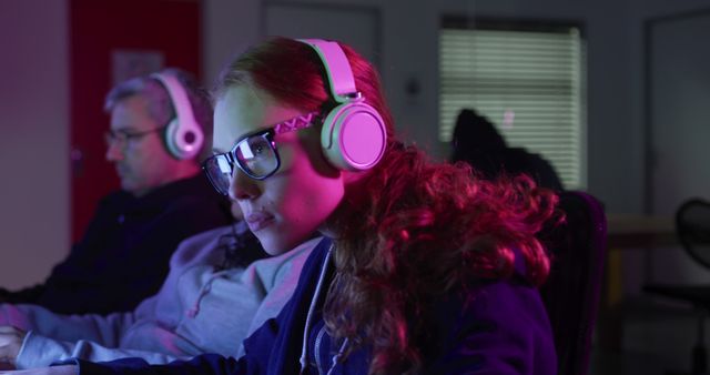 Young woman immersed in digital game competition, wearing VR headset and gaming glasses. Ideal for technology, esports, gaming industry content, promoting gaming equipment, and illustrating focused concentration in high-tech environments.