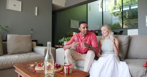 Smiling Couple Toasting Champagne at Home Celebration