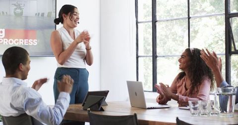Diverse Team Celebrating Success at Office Meeting