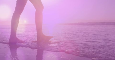 Caucasian Woman Walking Along Pink-Tinted Beach during Sunset - Download Free Stock Images Pikwizard.com