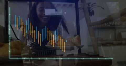 Smiling baker placing croissants in display case at bakery