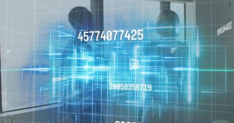 Businesswomen collaborating over holographic data analytics display in modern office