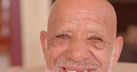 Senior Man Smiling in Cozy Living Room Setting