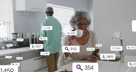 Senior Woman Engaged with Digital Life in Modern Kitchen