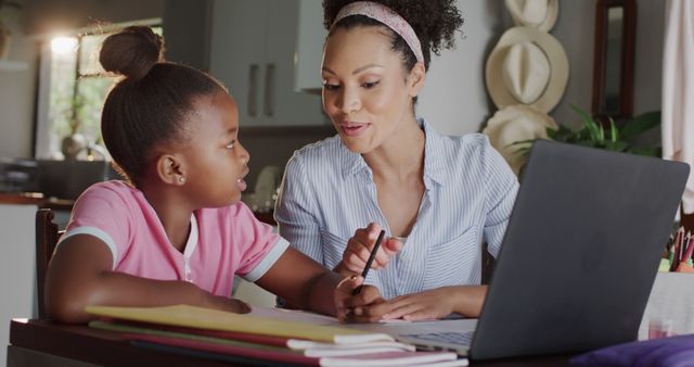 Dedicated Mother Helping Daughter with Homework at Home - Download Free Stock Images Pikwizard.com