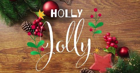 Handlettered holly jolly holiday flatlay on rustic wood with pine berries and ornaments