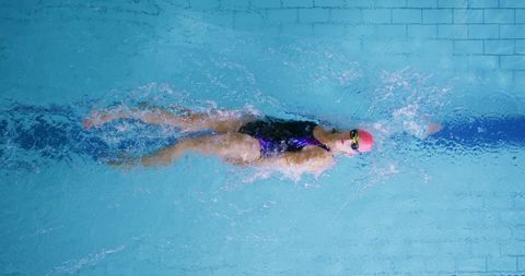 Female Athlete Swimming Backstroke in Indoor Pool - Download Free Stock Images Pikwizard.com