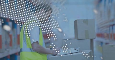 Warehouse worker scanning inventory with scanner and clipboard, logistics operations