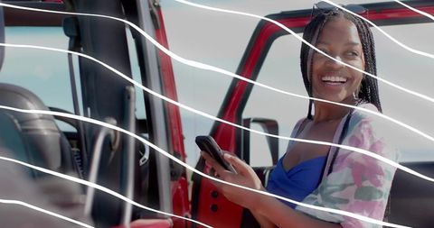 Smiling Woman Enjoying Outdoor Adventure by Red SUV
