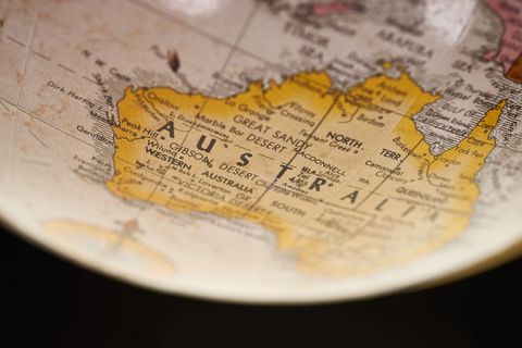 Vintage globe highlighting australia map close-up with warm sepia tones