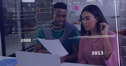 Colleagues Analyzing Financial Data on Computer Screen