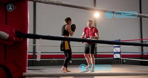 Female Boxer Sparring with Coach in Boxing Ring During Intense Gym Training