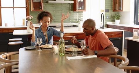 Couple enjoying meal in modern kitchen setting