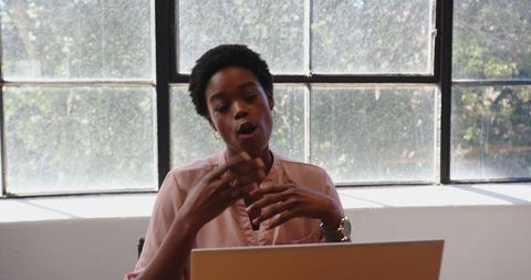 Confident African American Woman Speaking in Bright Office