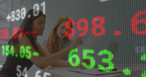 Diverse professionals analyzing financial market data overlay