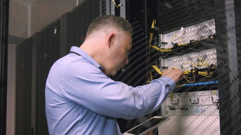 Technician Managing Data Servers in Control Room