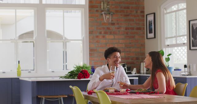 Happy biracial couple having valentine's day celebration meal at home. valentine's day celebration, romance and quality time together at home.