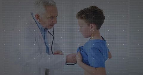 Pediatrician examining young patient with stethoscope in clinic