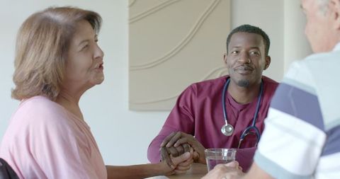 Senior couple converse with doctor for supportive consultation