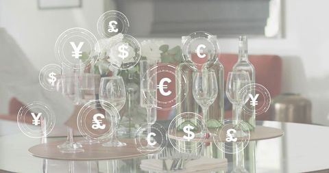 Global currency symbols floating over elegant tabletop glassware and interior centerpiece
