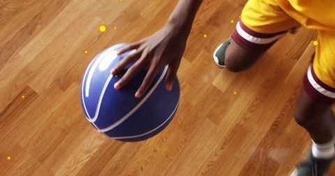 Athlete Dribbling Blue Basketball on Court