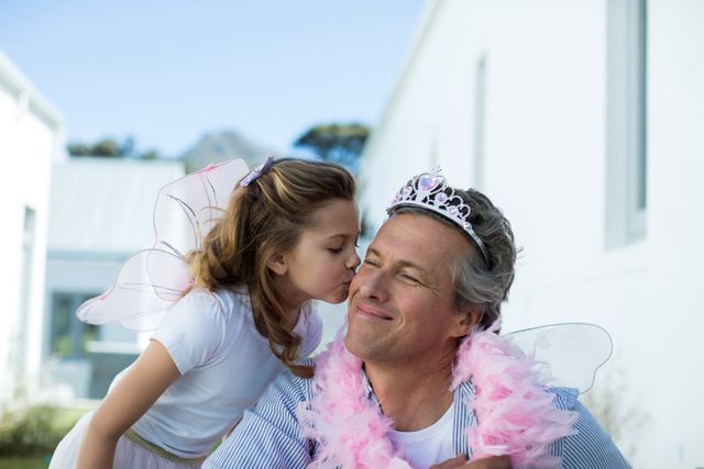 Daughter Kissing Father in Fairy Costume - Download Free Stock Photos Pikwizard.com